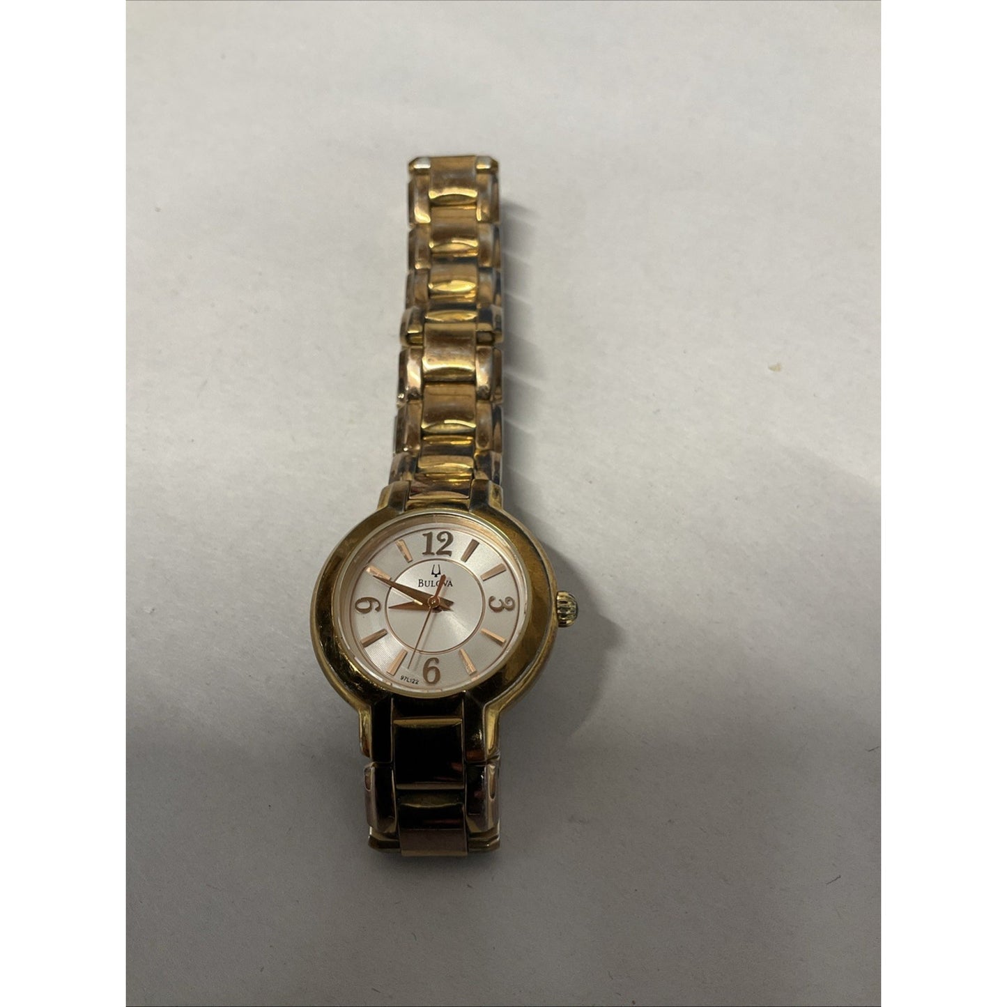 Bulova gold tone watch with silver face