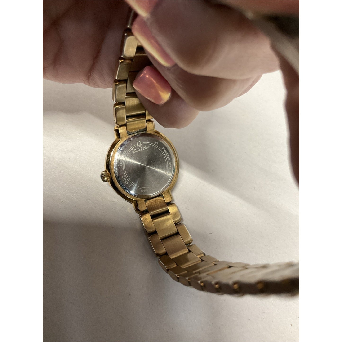 Bulova gold tone watch with silver face
