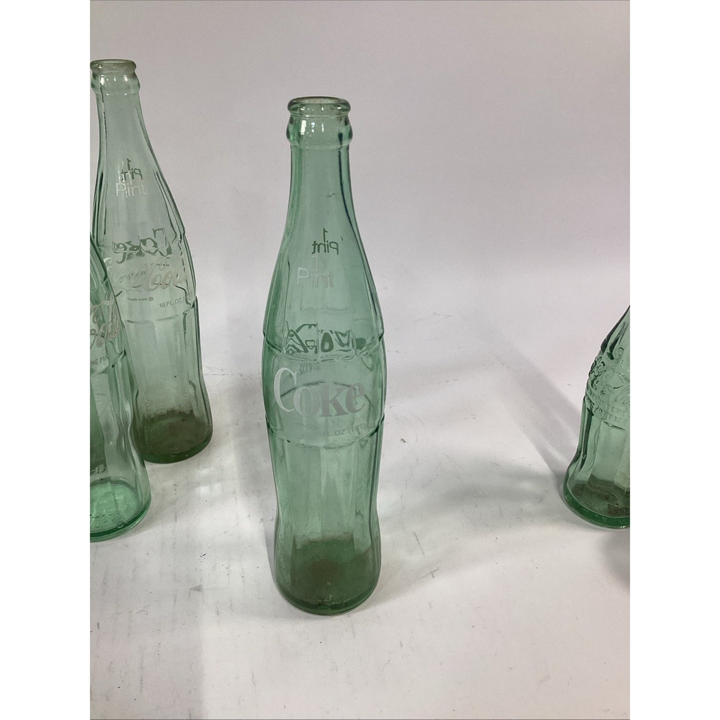 Lot of 7 Vintage Green Glass 16 Oz 1 Pint Coca Cola Bottles