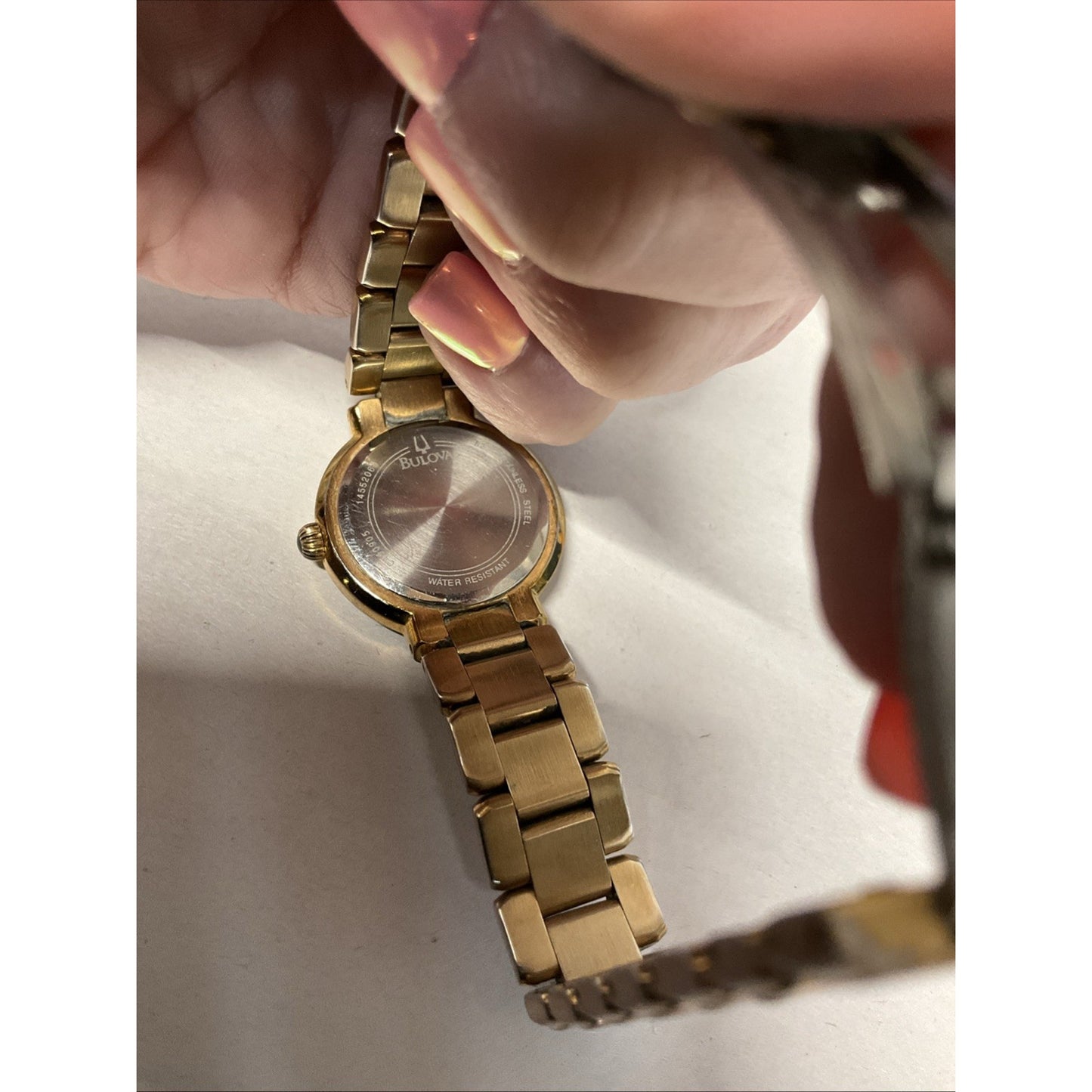 Bulova gold tone watch with silver face