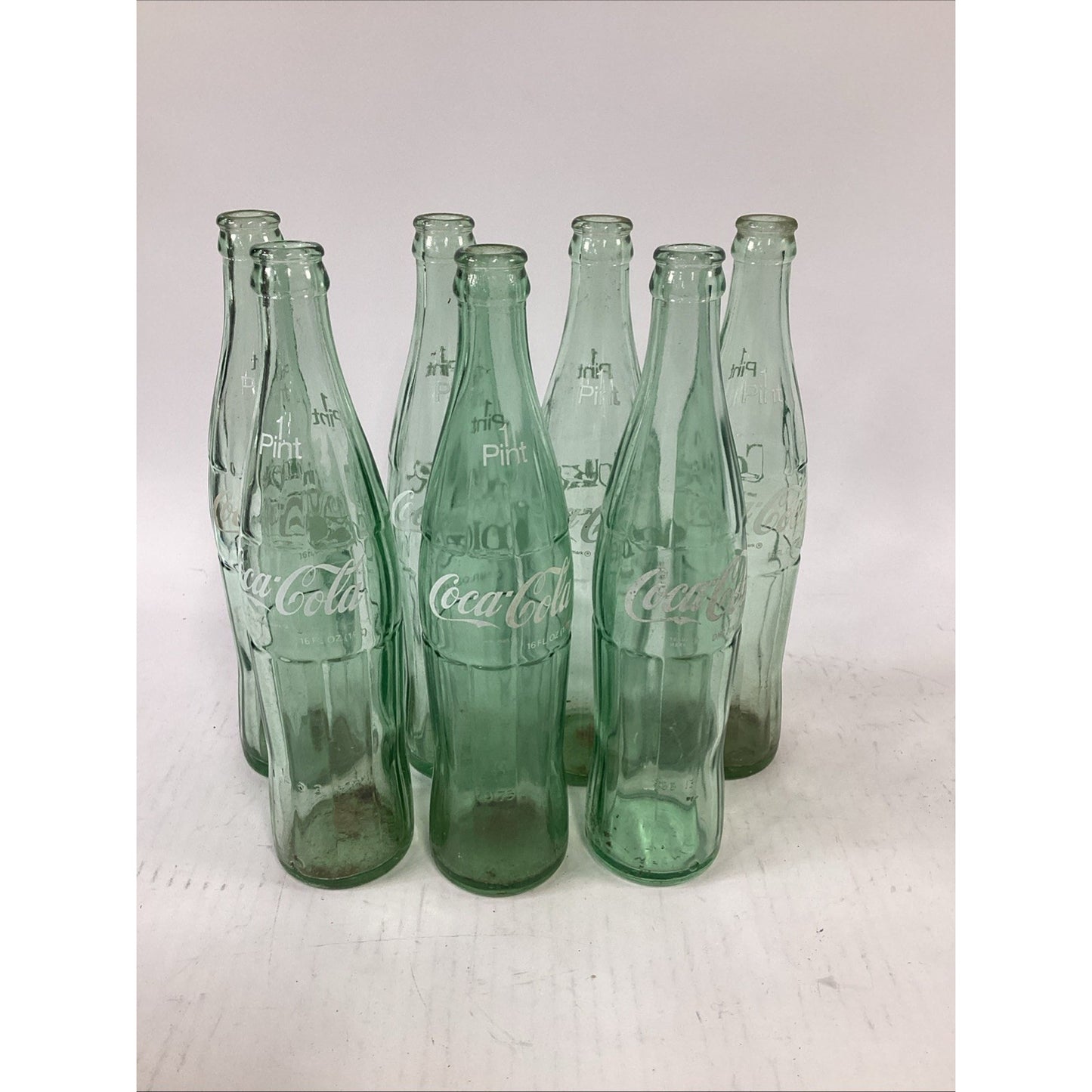 Lot of 7 Vintage Green Glass 16 Oz 1 Pint Coca Cola Bottles