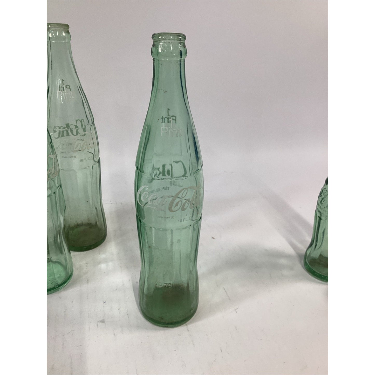 Lot of 7 Vintage Green Glass 16 Oz 1 Pint Coca Cola Bottles
