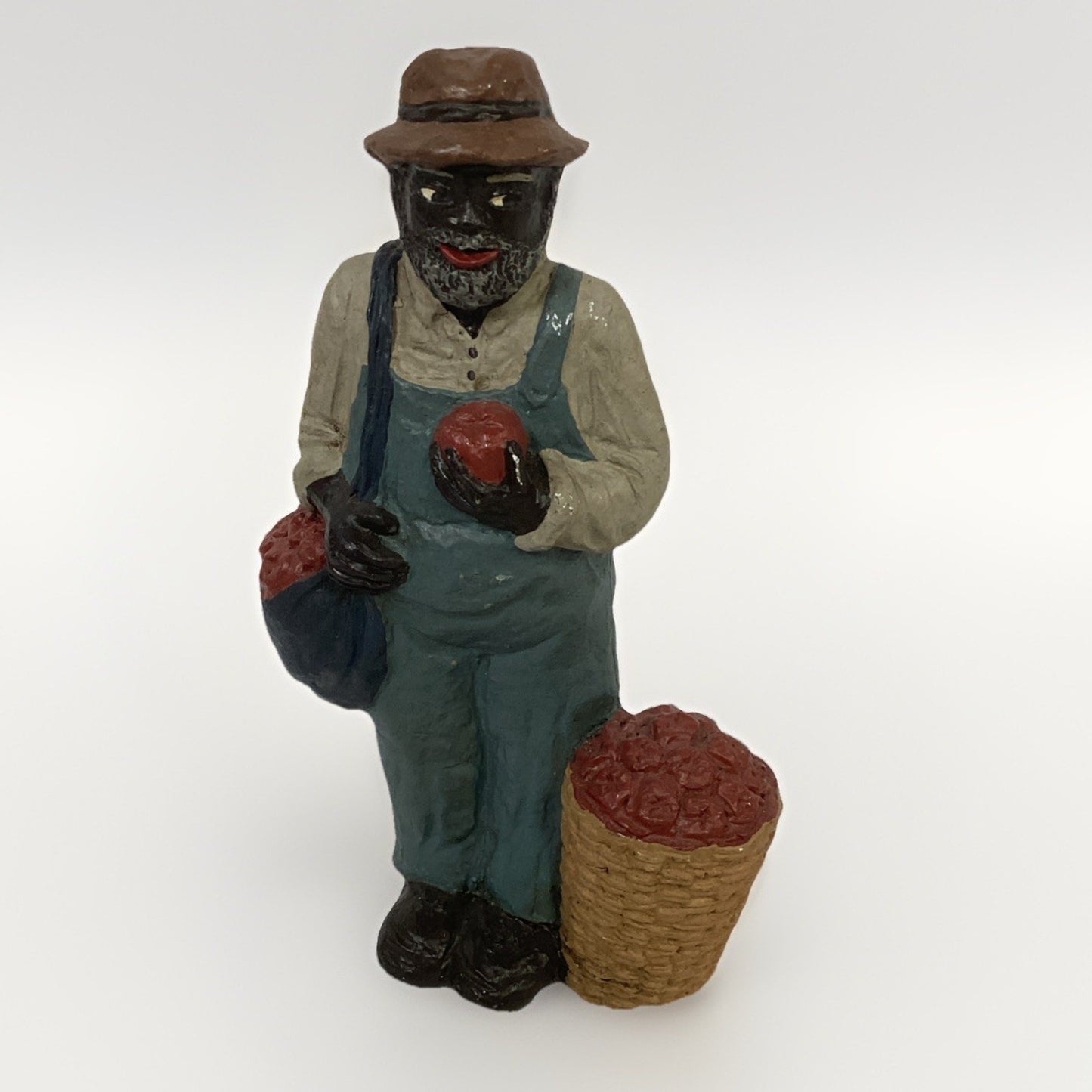 BLACK FARMER STATUE WEARING A HAT AND CARRYING FOOD BASKETS