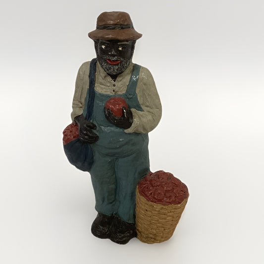 BLACK FARMER STATUE WEARING A HAT AND CARRYING FOOD BASKETS