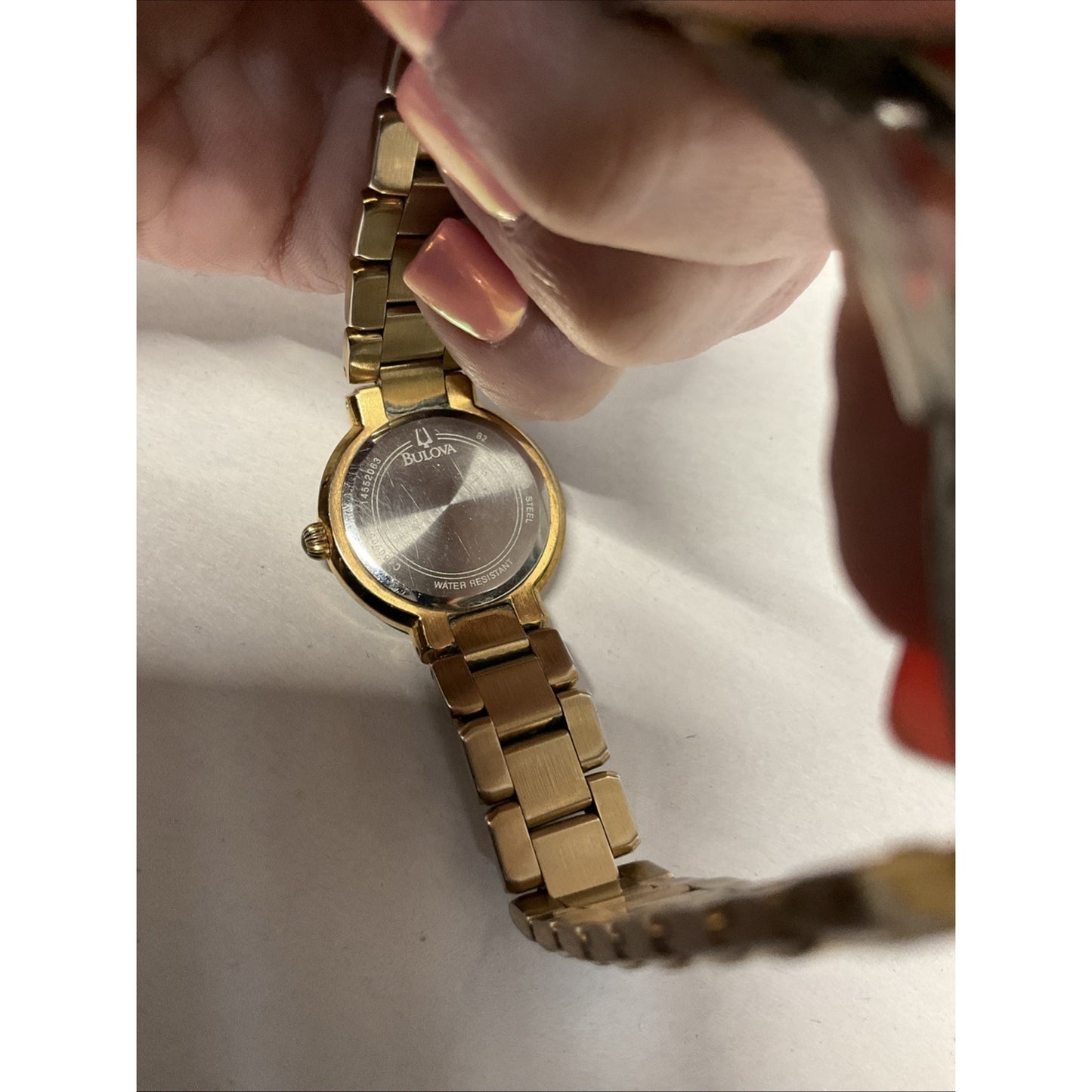 Bulova gold tone watch with silver face