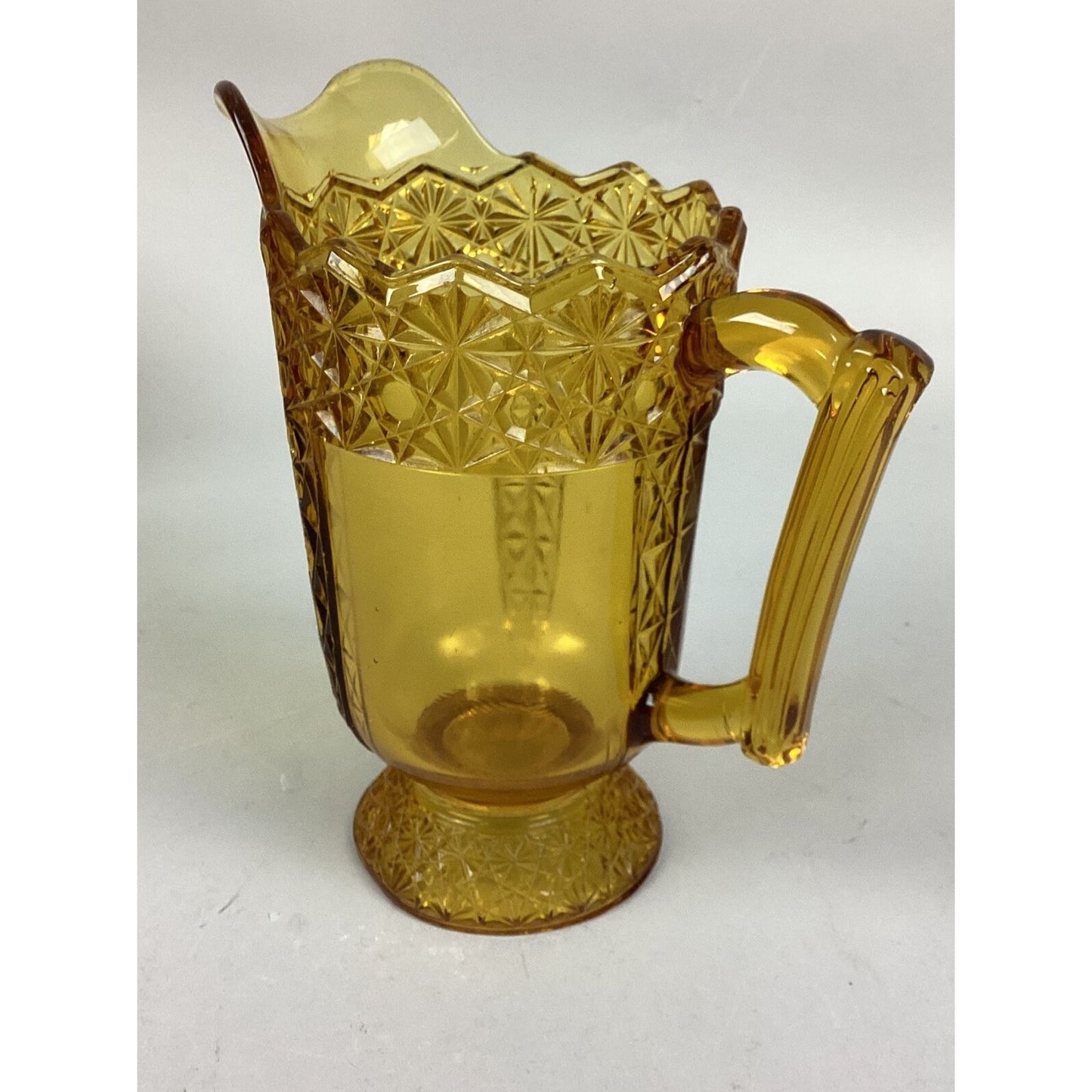 Vintage McKee Queen Daisy & Buttons Amber Glass Footed Pitcher - 8 1/4”